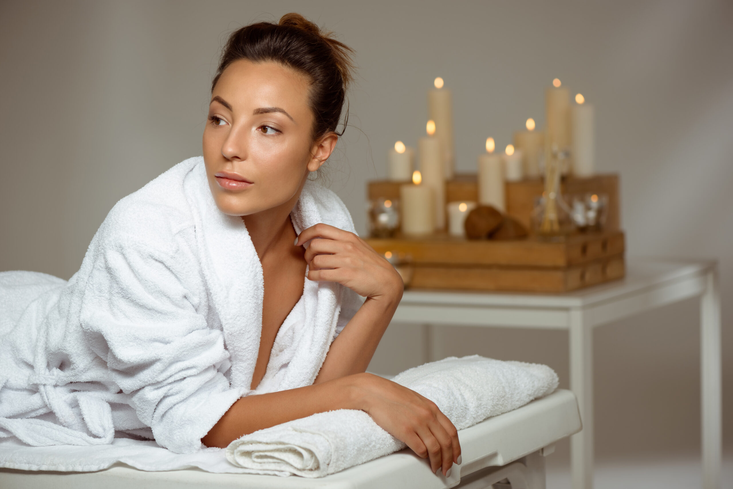 A confident woman with glowing, youthful skin receiving a facial aesthetic treatment in a modern med spa setting. The environment is clean, bright, and calming with soft lighting and minimal décor. A licensed provider is gently applying a facial treatment or holding a syringe near the cheek (for Botox/fillers), showcasing professionalism and care. Florida-inspired touches like palm leaves or sunlight filtering through a window suggest a Brevard County location. Text overlay: “Facial Aesthetics in Brevard County – River Med Spa